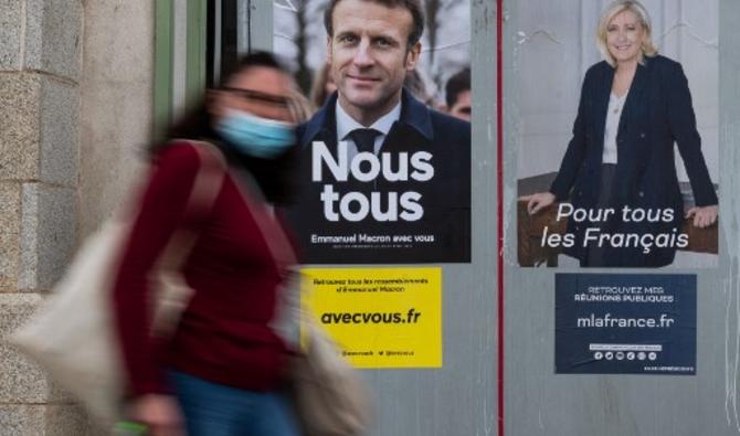 Des panneaux électoraux de Marine Le Pen et Emmanuel Macron à Paris. (Photo, AFP)