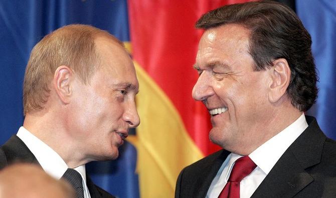 Dans cette photo d'archive prise en 2005, le chancelier allemand Gerhard Schröder écoute le président russe Vladimir Poutine à Berlin. (Photo, AFP)
